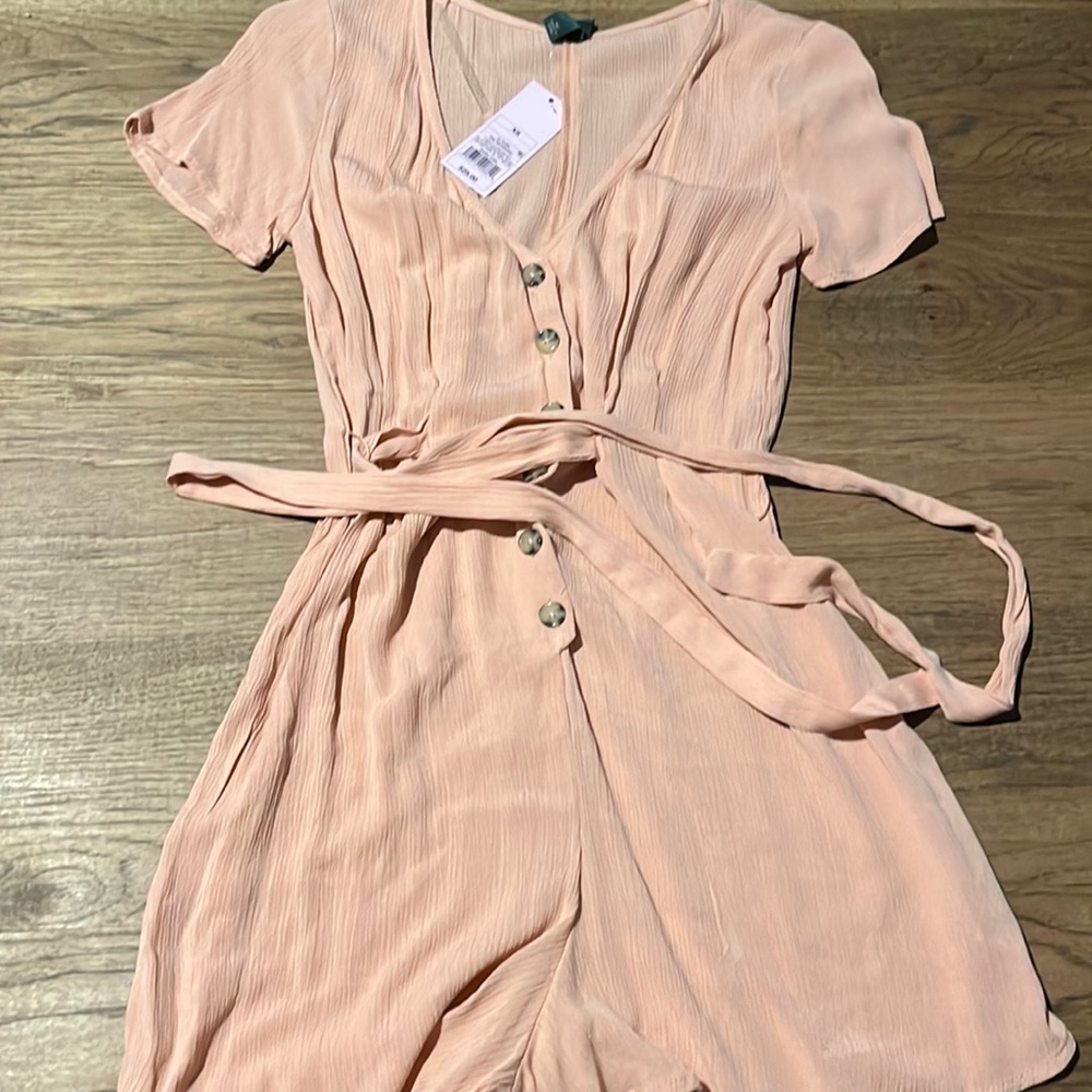 Blush button up romper. New with tag.